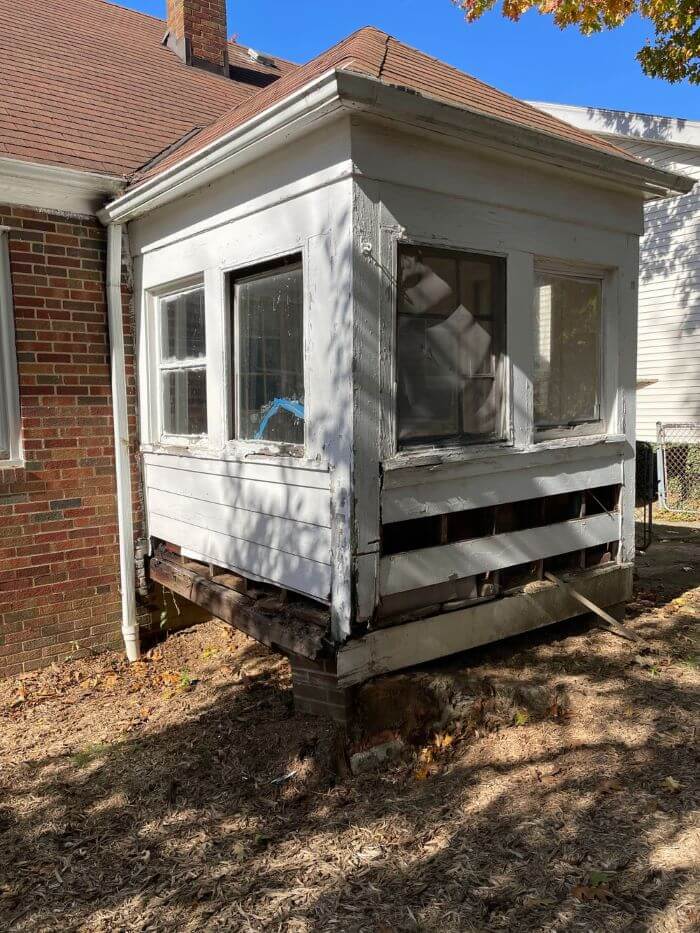 A collapsing porch after 25+ years of use by the same family (there was a tree that grew here as well)