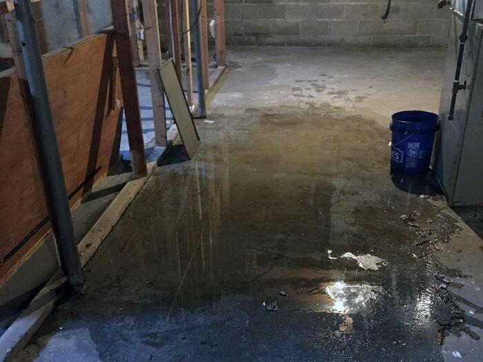 Water on the floor from a leaky basement